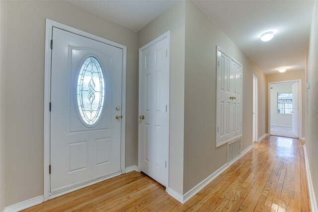 foyer with light hardwood / wood-style floors and a healthy amount of sunlight