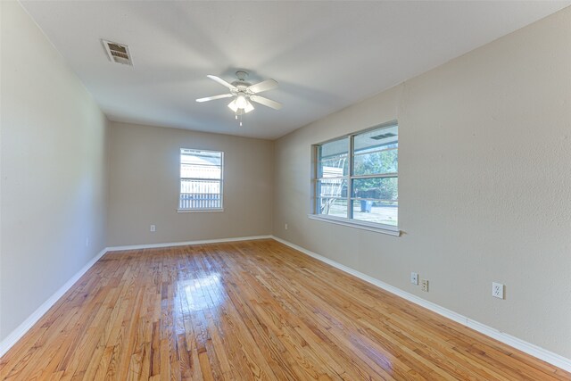 empty room featuring ceiling fan and light hardwood / wood-style flooring