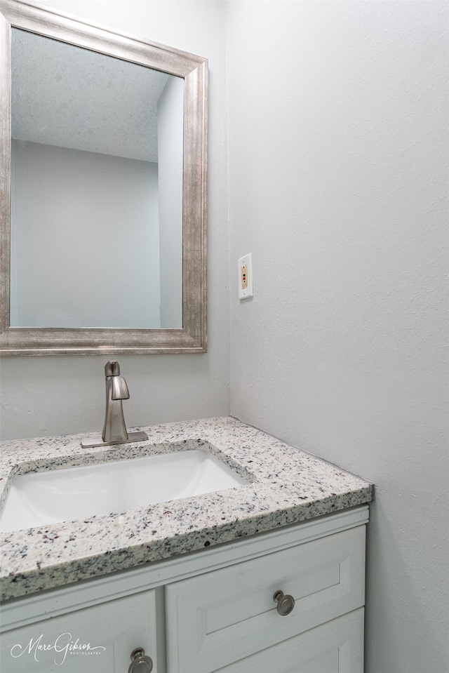 bathroom featuring vanity and a textured ceiling