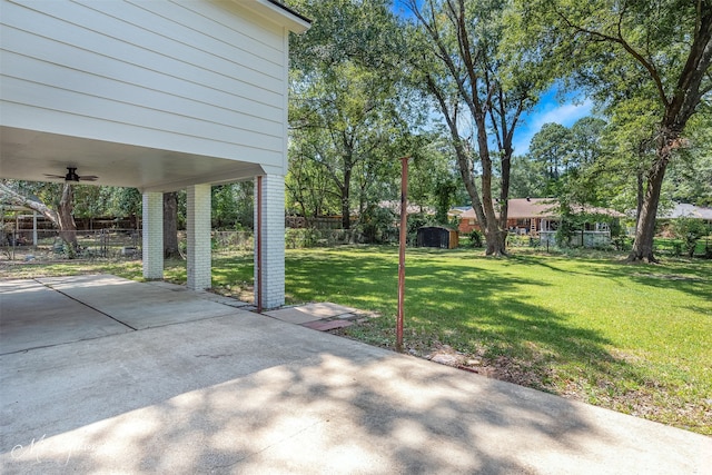 2011 Crabapple, Shreveport, LA 71118 - fenced backyard featuring a patio, ceiling fan, a shed, a carport, and concrete driveway