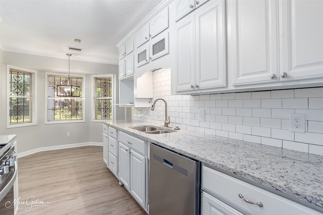 kitchen featuring white cabinetry, backsplash, sink, dishwasher, and light hardwood / wood-style flooring