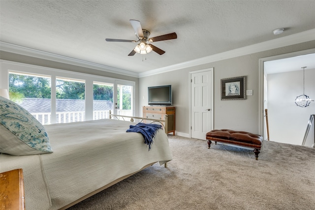 bedroom featuring a textured ceiling, carpet, ceiling fan, and crown molding