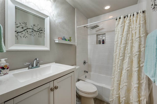 full bathroom featuring vanity, shower / bath combo, and toilet