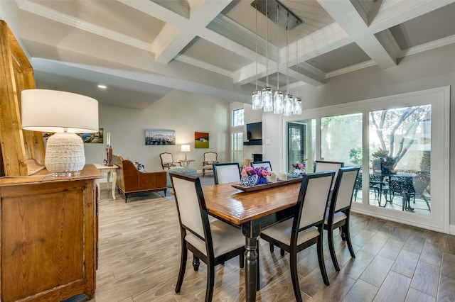 dining room with coffered ceiling, light hardwood / wood-style floors, and beam ceiling