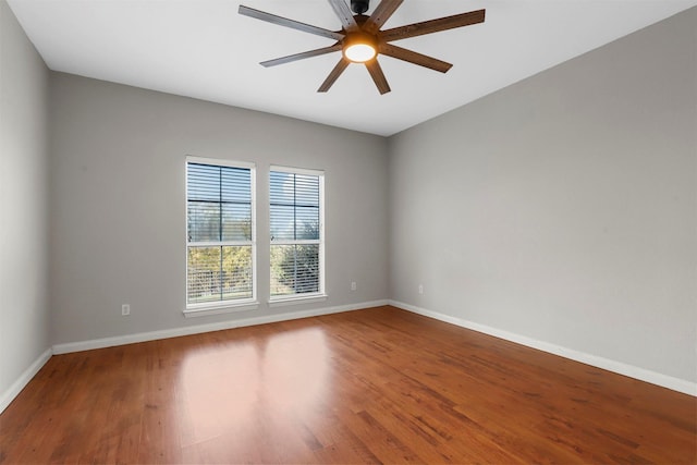 empty room with ceiling fan and hardwood / wood-style floors