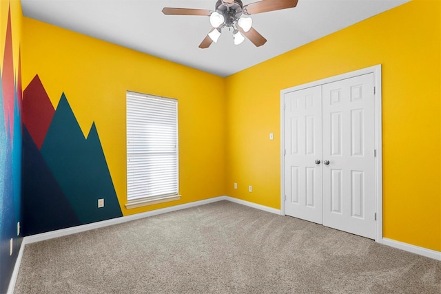 unfurnished bedroom with carpet, ceiling fan, and a closet