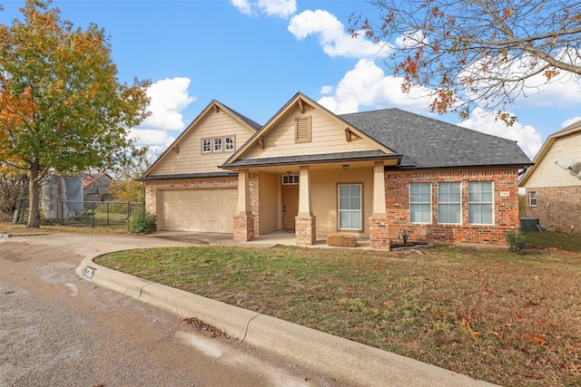 view of front of house featuring cooling unit, a garage, and a front lawn