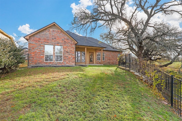 back of property featuring a lawn