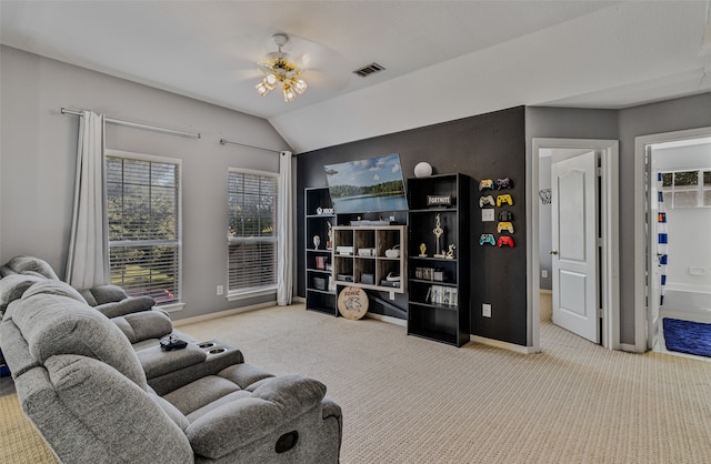 carpeted living room featuring ceiling fan and vaulted ceiling