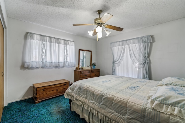 carpeted bedroom featuring a textured ceiling and ceiling fan