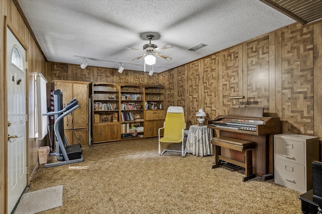 miscellaneous room with track lighting, light carpet, a textured ceiling, and ceiling fan