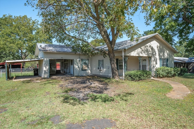 back of house featuring a carport and a lawn