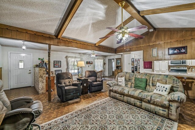 living room featuring parquet flooring, ceiling fan, a textured ceiling, vaulted ceiling with beams, and wooden walls