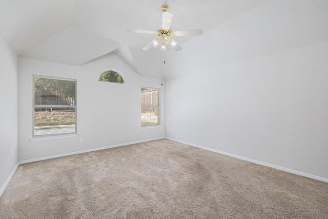 carpeted empty room with ceiling fan and vaulted ceiling