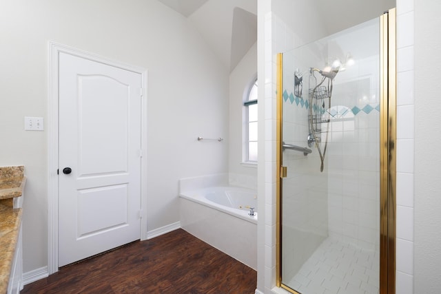 bathroom with wood-type flooring, separate shower and tub, and lofted ceiling