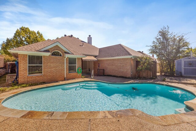 view of pool featuring a shed