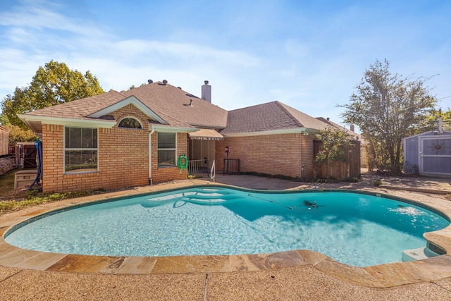 view of swimming pool with a storage shed