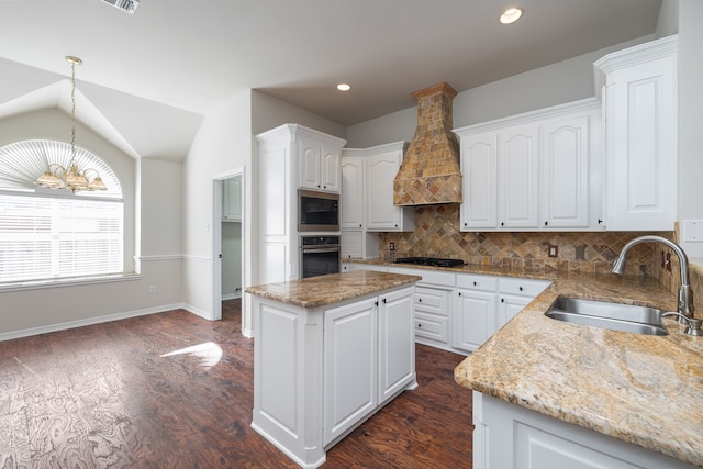 kitchen with white cabinets, sink, a center island, and appliances with stainless steel finishes