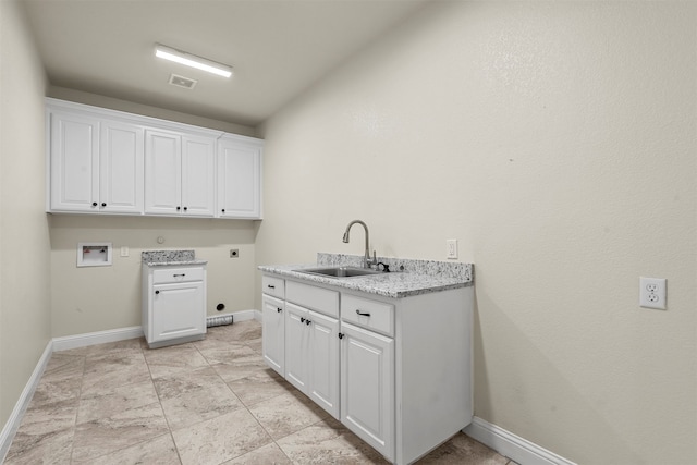 washroom featuring hookup for a washing machine, cabinets, hookup for an electric dryer, and sink