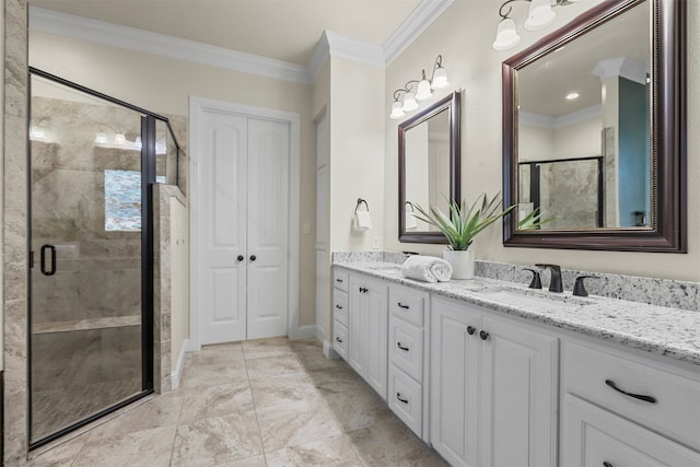 bathroom with a shower with shower door, vanity, and crown molding