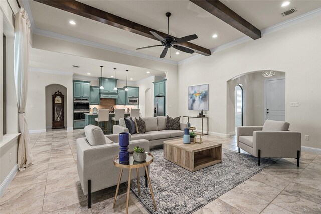 living room with ceiling fan, ornamental molding, and beam ceiling