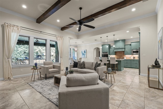 living room featuring ceiling fan, beam ceiling, and ornamental molding