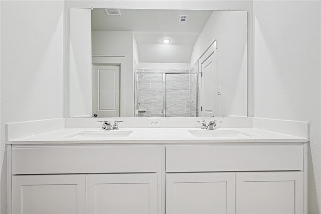 bathroom with double vanity, a sink, visible vents, and a shower stall