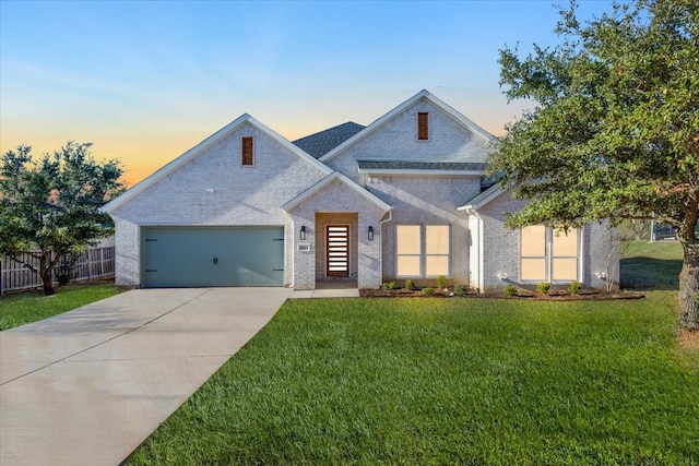 view of front of house featuring a yard and a garage