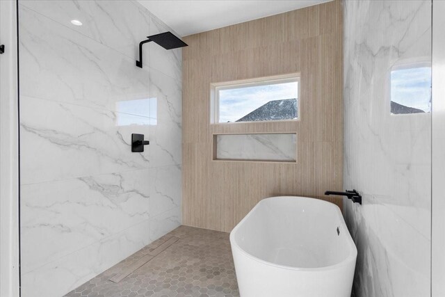 bathroom with tile patterned flooring and independent shower and bath