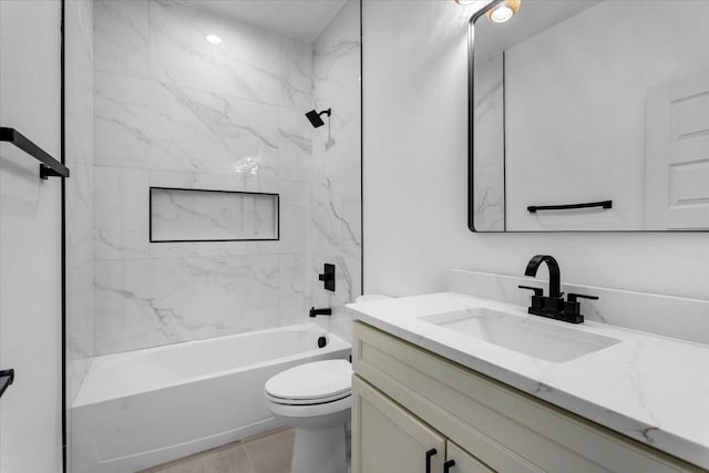 full bathroom featuring tile patterned floors, vanity, toilet, and tiled shower / bath