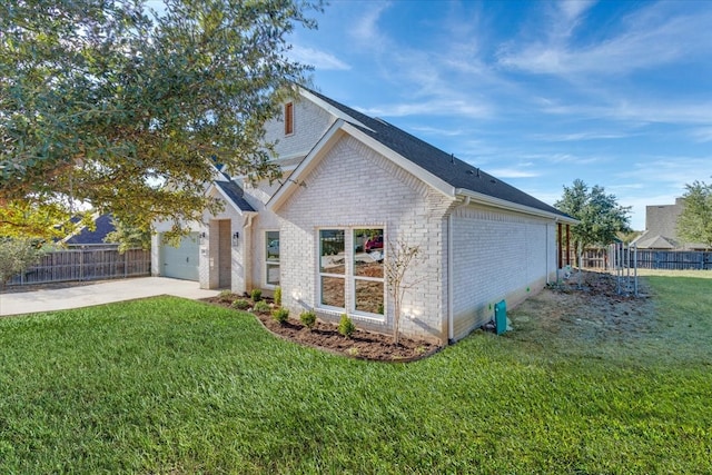 view of side of home with a lawn and a garage