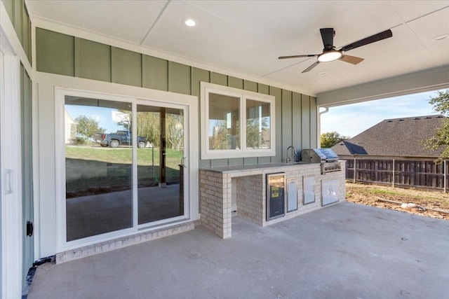 view of patio / terrace featuring area for grilling, ceiling fan, sink, and an outdoor kitchen