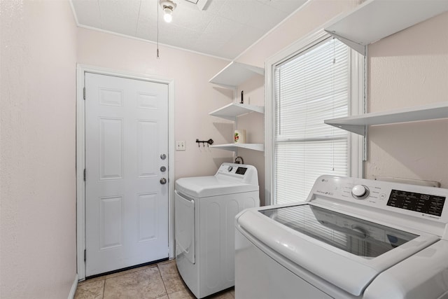 laundry area featuring light tile patterned flooring and washer and dryer