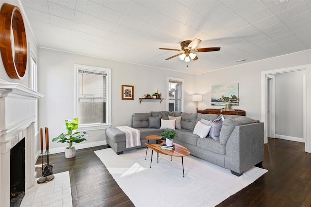 living room featuring ceiling fan and dark hardwood / wood-style flooring