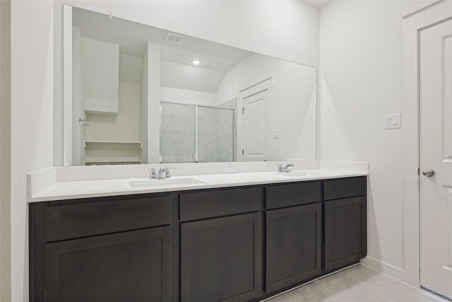 full bath with double vanity, a stall shower, visible vents, and a sink