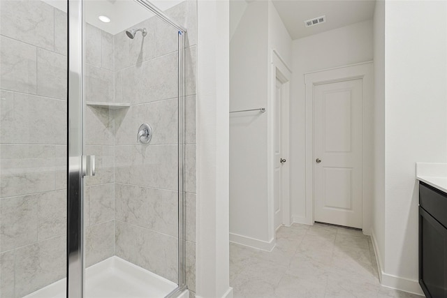 full bathroom with a shower stall, visible vents, baseboards, and vanity