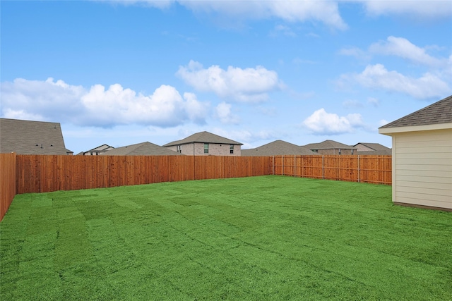 view of yard with a fenced backyard