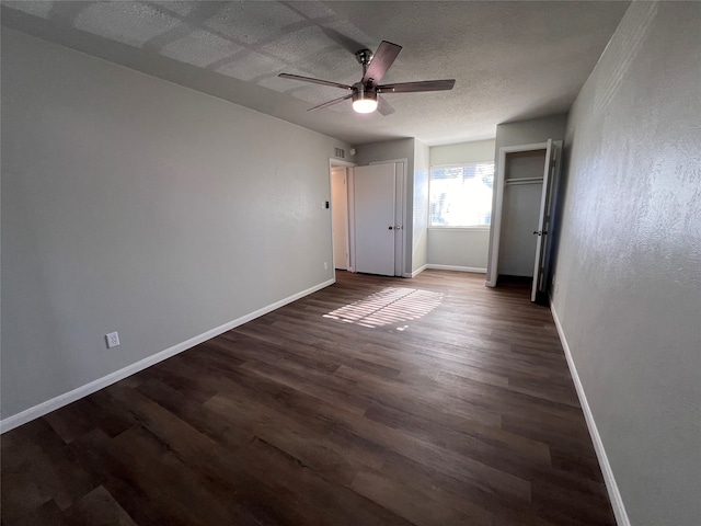 unfurnished bedroom with ceiling fan and dark hardwood / wood-style flooring