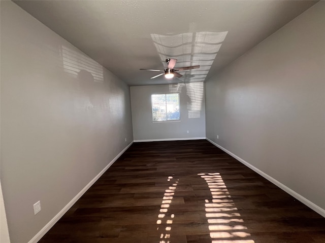 spare room with dark hardwood / wood-style flooring, ceiling fan, and lofted ceiling