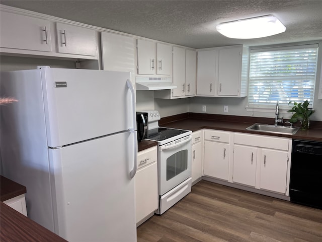 kitchen featuring a textured ceiling, white appliances, dark wood-type flooring, sink, and white cabinetry