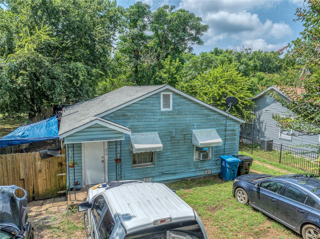 614 W Collins St, Denison, TX 75020 - view of front of home featuring roof with shingles and central AC unit