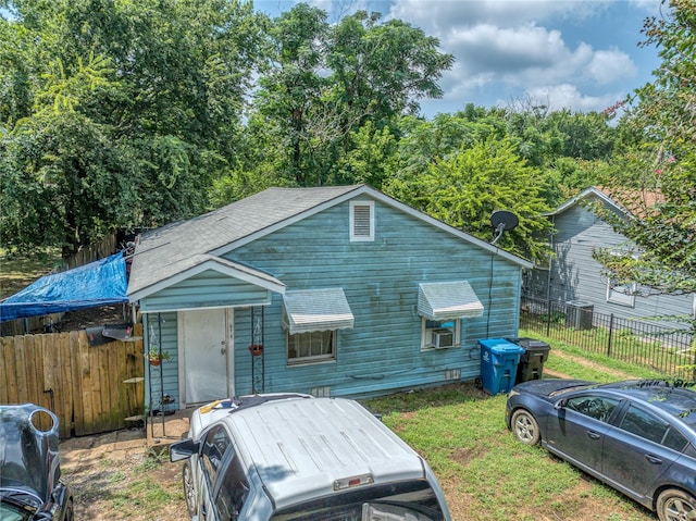 614 W Collins St, Denison, TX 75020 - view of front of home featuring roof with shingles and central AC unit