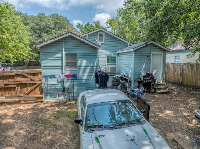 rear view of property featuring cooling unit