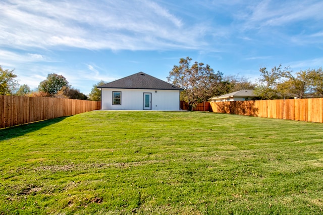 back of house with a yard