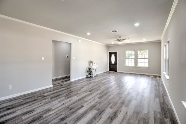 empty room featuring hardwood / wood-style flooring, ceiling fan, and ornamental molding