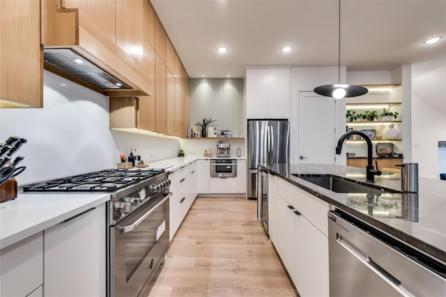 kitchen featuring stainless steel appliances, white cabinetry, and sink