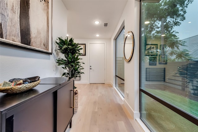 hallway with light hardwood / wood-style flooring