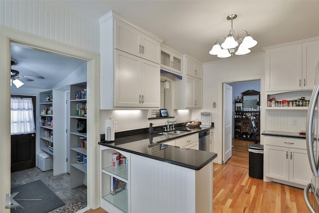 kitchen with white cabinets, kitchen peninsula, and decorative light fixtures