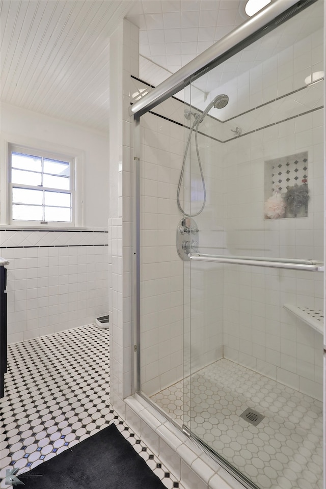 bathroom featuring walk in shower and tile patterned flooring