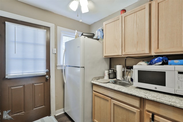 kitchen with dark hardwood / wood-style floors, light brown cabinets, sink, white appliances, and ceiling fan